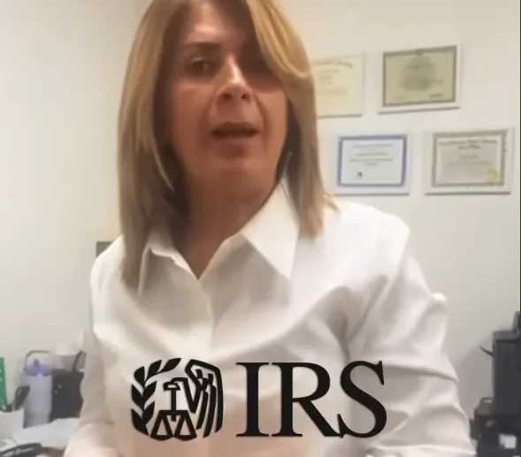 Image of woman speaking into camera. There's an IRS logo on the foreground. The woman is wearing a white business shirt.